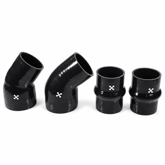 Four LP300 black silicone couplers, two elbows and two hump couplers with white XOTIC emblems, on a square white background