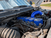VC300 blue valve covers installed in a 12V Cummins engine bay with a matching blue intercooler pipe